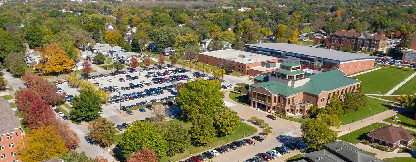 An aerial view of the campus with lush trees and buildings.